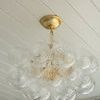 Semi-flush mount displayed on white paneled ceiling with wallpapered wall in background