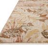 Rug angled to show low pile texture and finely fringed edge in natural and spice color palette