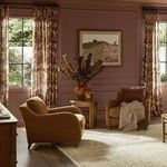 Two Lynne chairs styled in pink room with floral curtains and art on wall