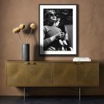 Slightly different lighting and shadow on framed Warhol photo above gold cabinet with vase and books