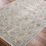 Close-up of rug corner highlighting flat weave texture and subtle color variations in blue, beige, and black
