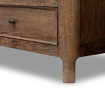 Lower corner showing angled leg shape and continuous carved wood edge