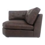 Side profile of chair highlighting tufted back cushions and thick leather seat cushion