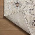 Corner of rug folded back demonstrating sturdy woven backing