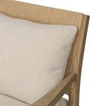 Close-up of beige textured fabric on Godfrey Chair pillow and part of armrest