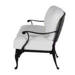 Side angle displaying curved armrest and thick white seat and back cushions