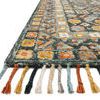 close-up of rug corner showing thick braided tassels and textured wool weave