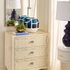Sara end table shown in room context close-up styled with blue and white decor on top