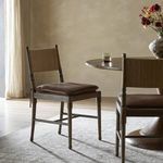 Same dining room scene from alternate angle focusing on chair arrangement and light floor rug
