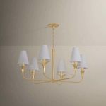 Quill Chandelier hanging in room with beige wall background