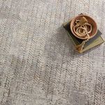 Close-up on Sylvana Trellis rug with bowl and beaded decor emphasizing soft texture and pattern