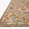 Low-angle side view showing thick pile height and intricate multi-color border on Padma Grey Multi Rug