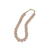 Oblique side view of blush pink vintage sea glass beads with rounded smooth edges