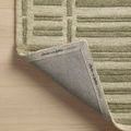 Bradley Sage Olive Rug corner folded back revealing branded fabric underside with Chris Loves Julia and Loloi markings.