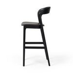 Side perspective showing curved backrest and angled rear legs