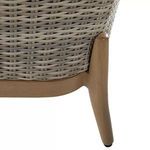Close-up showing wooden leg with natural finish joining tightly woven wicker frame