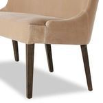 Low angle of dark tapered parawood legs contrasted against plush taupe velvet upholstery