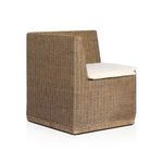 Angled horizontal shot highlighting thick weave of natural rattan arms and back