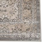 Detailed close-up of embroidered metallic highlights on floral lattice near rug corner