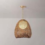 Pendant lit to reveal glowing opal shade through the woven abaca net, highlighting texture and warm tones