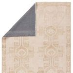 Back corner of rug flipped revealing dark gray non-slip backing