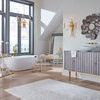 Bar cart shown from a side angle in bathroom setting with modern cabinet and decorative wall mirror