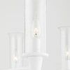 Tight close-up of a single clear textured glass cylindrical shade and flame-shaped bulb