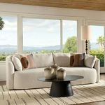 Mackay Sofa styled in a bright living room with patterned pillows and a black round coffee table