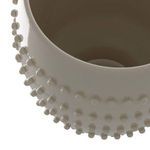 Top-down close-up revealing inside of vase and rounded bead pattern on rim.