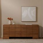 Gia dresser styled in a neutral room setting beneath abstract wall art with vase and decor on top