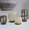 Group of four vases combining the dark green plaid glass vases with cream-colored swirl glass vessels