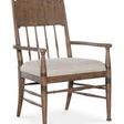 Americana Upholstered Seat Arm Chair with spindle back, carved accents, oak veneer frame, honey brown finish, and beige fa...