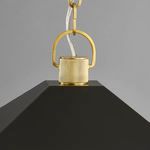 Close-up of aged brass chain attachment and textured collar on black lantern roof
