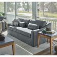 Chesapeake End Table indoors on porch beside gray upholstered sofa with books and small decorative items on table