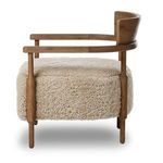 Side profile of Bennett Chair highlighting turned dowel leg and cushioned seat depth