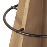 Close-up detail of the dark metal circular footrest attached to the wooden base panels
