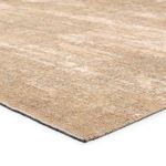 Close-up of the Leshni Medallion rug's tan textured weave and edge stitching