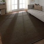 Sena rug styled in a living room with gray sofa and white curtains, showing full rug in space