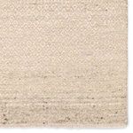 Zoomed-in view of small-scale trellis weave pattern and speckled wool fibers on rug surface