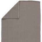 Overlap fold showing front and back sides of dense woven solid gray rug