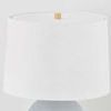 Close-up of white textured drum lamp shade with wooden finial on top