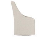 Side profile showing curved armrest and chair’s sloping backrest in soft gray upholstery