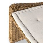 Angle detail emphasizing woven rattan texture and beige cushion tufting