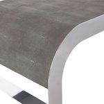 Close-up on edge showing detailed faux shagreen texture and polished stainless steel waterfall frame