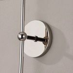 Close-up of polished nickel round wall mount and connecting arm