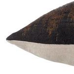 Close-up side view showing pillow's soft woven texture and beige fabric back panel