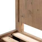 Close-up of footboard inset panel with natural wood finish and subtle knot details