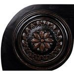 Close-up on turned leg and stretcher connecting curved scroll sides with hand-rubbed black finish