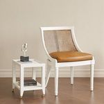 Isadora Tea Table beside white cane and leather chair in a minimalist room with hardwood floor