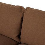 Close-up of plush seat cushion with stitched edges and soft linen material